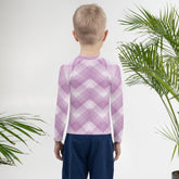 Child playing in Fairy Garden Sparkle Kids Rash Guard outdoors.
